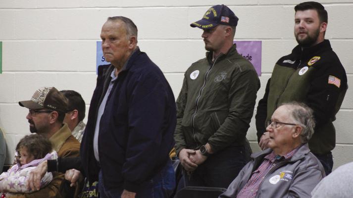 STANDING, JIM MISENHELTER (standing, from left), David Savage and Theodore White participate as their branch is announced.