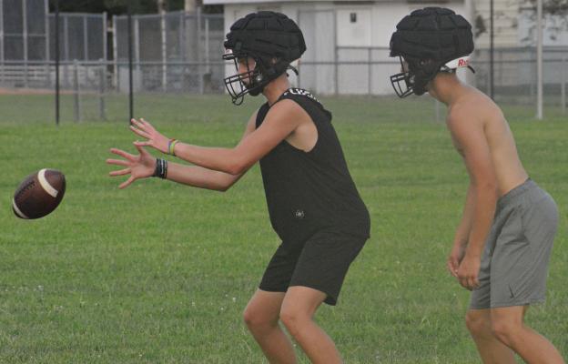 ZAKE RODENBERG (left) and Zack Schoeneck run through Orrick’s offense during the first day of practice for high school fall sports programs. Look for additional area fall sports practice photos on page 12. SHAWN RONEY | Staff