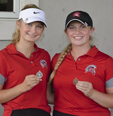 RICHMOND SOPHOMORE Lyla Best (left) and junior Karoline Dooley display their medals for placing in the top 10 at the Richmond Invitational. SHAWN RONEY | Staff