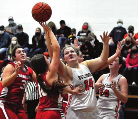 JUNIOR MORGAN FINLEY tries to grab a rebound for the Bulldogs during their Dec. 5 loss to visiting Carrollton, a fill-in opponent because Braymer could not play Hardin-Central. SHAWN RONEY | Staff