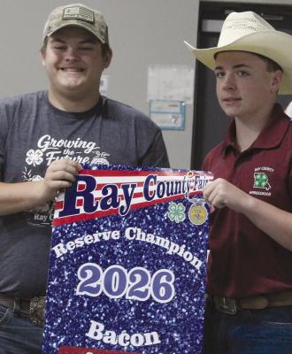 HUNTER CROWLEY (left) receives the Reserve Champion Bacon banner.
