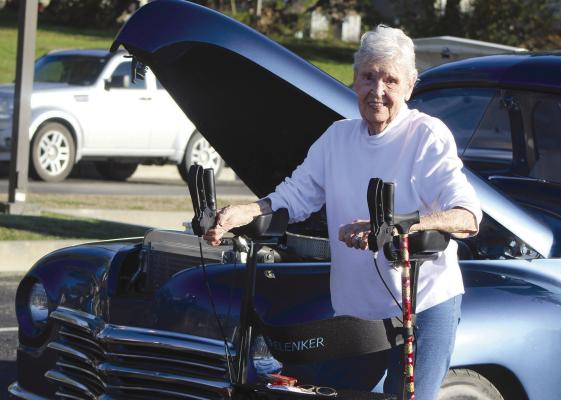 A CLASSIC CAR catches the attention of Marjie Jones during Fall Fest. SHARON DONAT | Staff