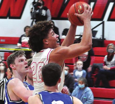 KEYSHAUN ELLIOTT, No. 20, drives through Summit Christian Academy’s stingy defense to attempt a layup during the Spartans’ Jan. 29 meeting with the visiting Eagles for the Richmond Winter Classic boys title. SHAWN RONEY | Staff