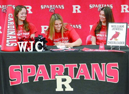 LILY SUMMERS (center) is going from cheering on the Spartans at Richmond High School to cheering on the Cardinals at William Jewell College. SHAWN RONEY | Staff