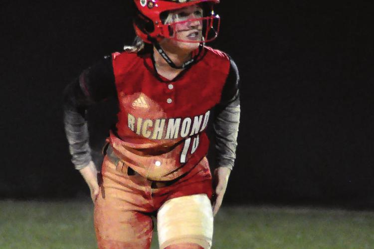 SENIOR KAYDEN BOWMAN gets some of the dirt off of her uniform and stands ready to run at second base during Richmond’s Class 3 District 7 meeting with Oak Grove Tuesday at Odessa. SHAWN RONEY | Staff