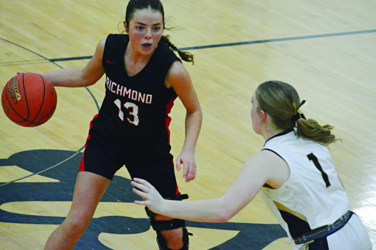 RICHMOND JUNIOR Genevieve Didier dribbles and surveys the floor while guarded by Excelsior Springs junior Kayden Rogers in district title action. SHAWN RONEY | Staff