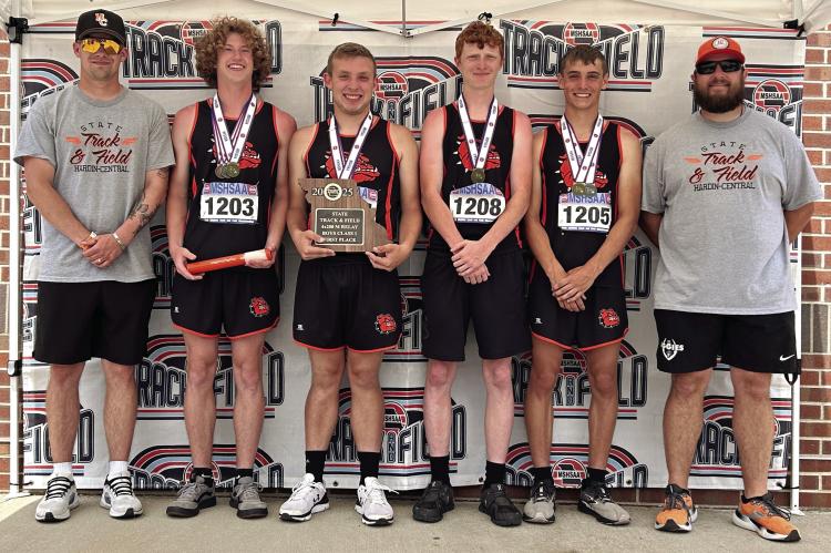THE HARDIN-CENTRAL boys relay runners and their coaches display hardware they’ve won at the Class 1 state meet. Enjoying the triumphs are assistant coach Zac Smith (from left), Kalel Bowman, Max Clariday, Kaden McGinnis, Brody Fifer and varsity head coach Andrew Watson. COURTESY OF THE HARDIN C-2 SCHOOL DISTRICT| Submitted