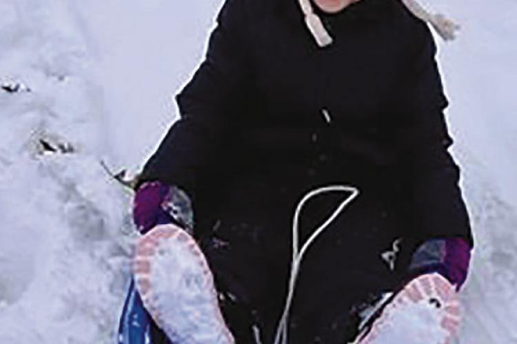 EVELYN BURKEYBILE (front) sleds down, yelping with snowy joy. TIFFANY BURKEYBILE | Submitted