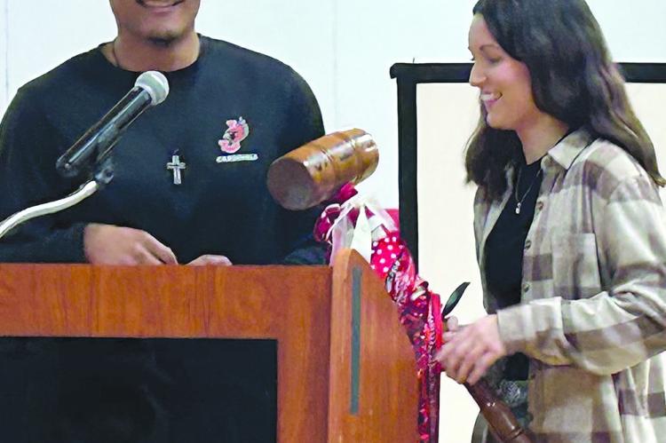 HAYDEN HAPPY passes the student council gavel to Alyana Quick. KAITLYN RIDDLE | Staff