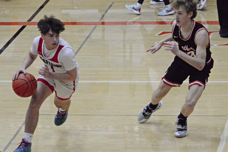 DRYDEN HENDRIX dribbles right for the Spartans during the first half of their Feb. 29 Class 4 District 15 Tournament semifinal meeting with Oak Grove at Oak Grove. SHAWN RONEY | Staff