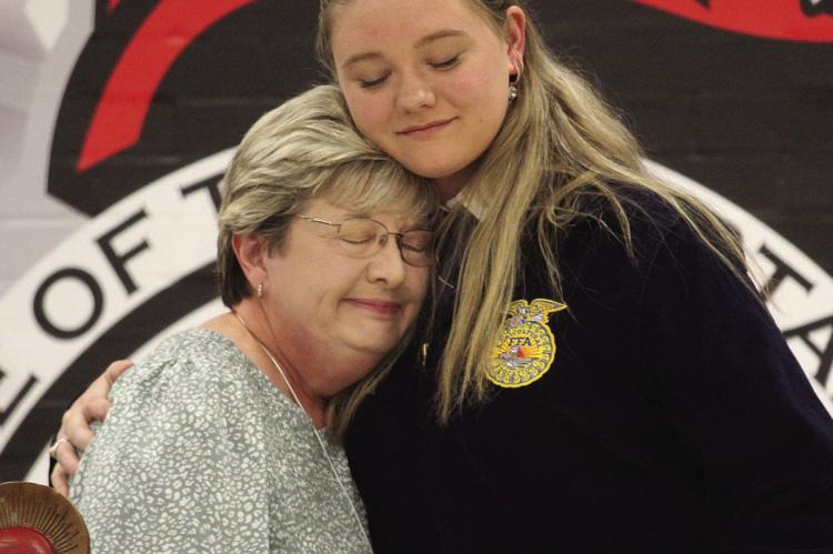 Brenda Hamm (left) recognizes Addison Burk with the Steve Hamm Memorial Scholarship, which honors the legacy of longtime agriculture supporter Steve Hamm. MIRANDA JAMISON | Staff