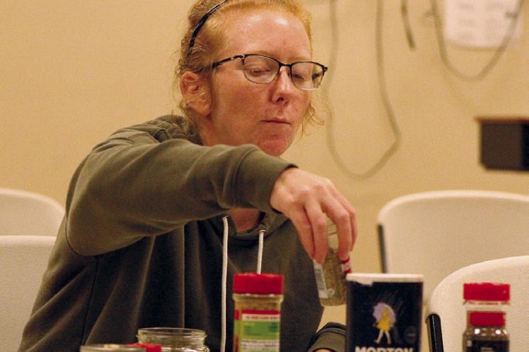 RACHELL BEACH combines herbs and salt while learning to make Greek seasoning. SHARON DONAT | Staff