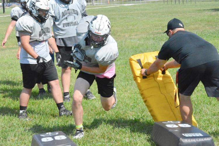KOBE GIBSON, No. 11, swerves to his right to avoid a blocking dummy Aug. 18 on the practice fields at Hardin-Central. Gibson, a senior at Norborne, plays for the Norborne Hardin-Central co-op varsity 8-man football team. He and his fellow Aggies will open their regular season Friday at Sweet Springs. SHAWN RONEY | Staff