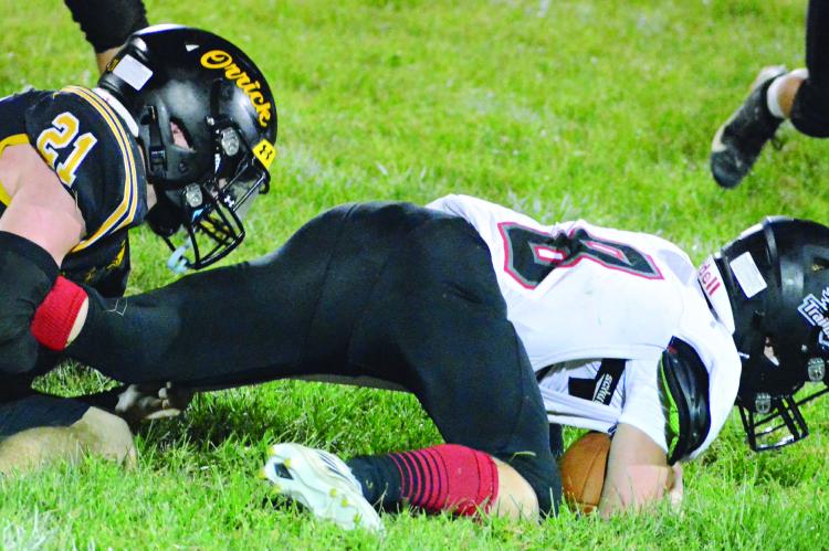 LUCAS WALKER (left) takes down Northland Christian’s Hudson Moss during the second half of Orrick’s seasonopening win. SHAWN RONEY | Staff