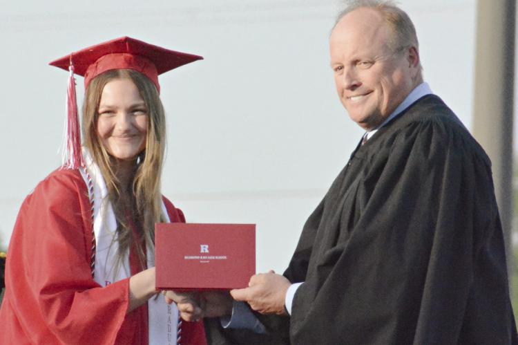 KATIE PIERSON (left), shown receiving her diploma from Richmond High School, is taking her softball skills to North Central Missouri College. SHAWN RONEY | Staff
