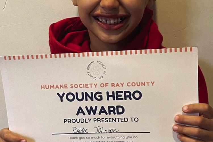 RAIDER JOHNSON receives an award for helping the HSRC.