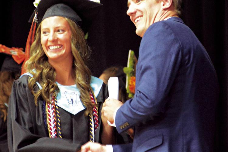 ESTER KINCAID (left) receives her high school diploma from Hardin-Central. SHAWN RONEY | Staff