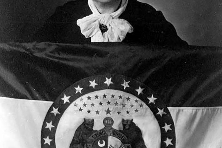 MARIE OLIVER standing behind the original Missouri State Flag she designed, c. 1943. STATE HISTORICAL SOCIETY OF MISSOURI | Submitted