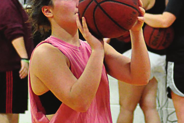 HARDIN-CENTRAL SENIOR Brogan DeMint practices free throws as she takes a one-day-at-a-time approach to the varsity girls basketball season. SHAWN RONEY | Staff