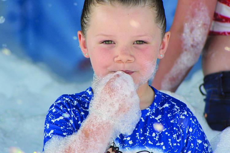 KIDS OF ALL ages enjoyed foamy fun, including Zailee Kilpatrick. SHARON DONAT | Staff