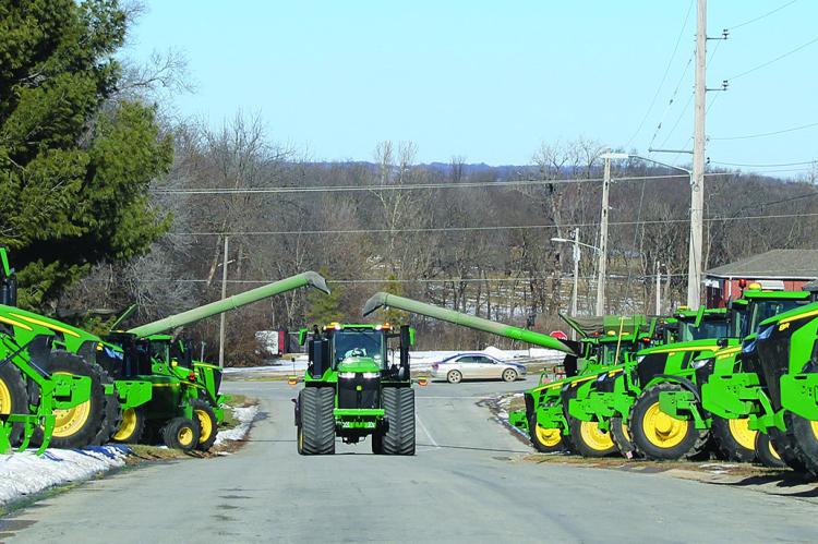 A FINAL TRIBUTE – Local farmers line the funeral procession route, flashing their tractor lights in a solemn farewell to Steve Hamm. A pillar of the agricultural community, Hamm’s dedication and kindness left an indelible mark not only on local farming but on the hearts of all who knew him. SHARON DONAT | Staff