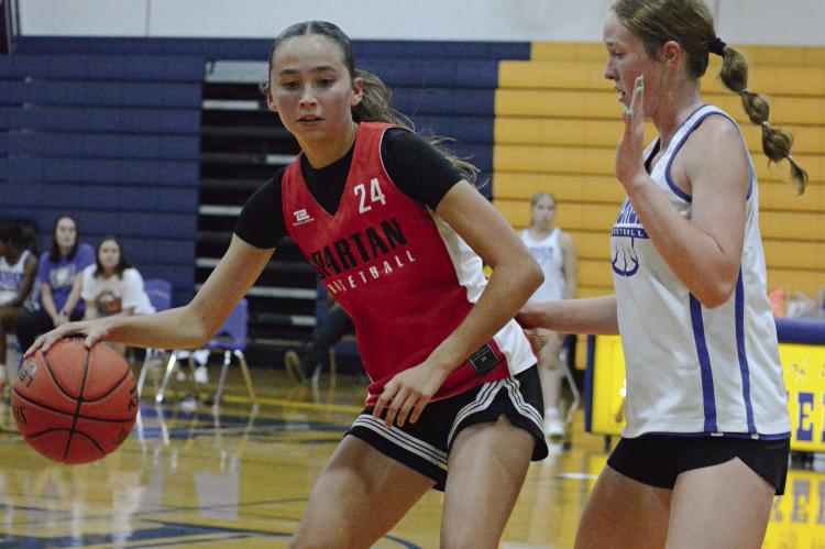 BRYLEE CASTILLEJA (left) and her Richmond teammates get a look at Missouri River Valley Conference-East Division rival Lafayette County of Higginsville during summer-league play. SHAWN RONEY | Staff
