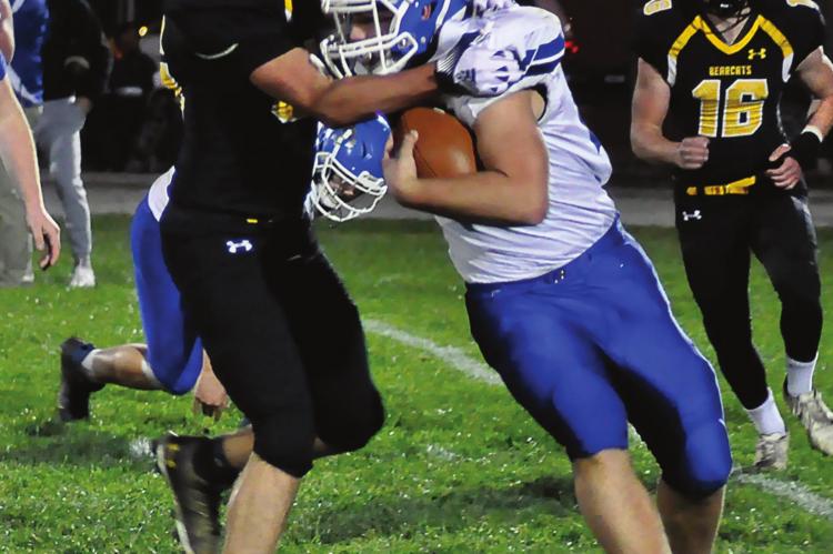 SENIOR MASON FURNER goes high as he attempts to make a second-quarter tackle for Orrick during the Bearcats’ 60-22 District 3 Tournament victory over Southwest/Hale/Tina-Avalon on Nov. 5 at Simmons Field. SHAWN RONEY | Staff