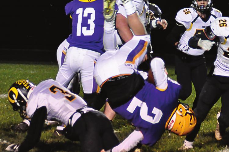 ON THE GROUND, Orrick junior Zander Stevinson upends Wildkats quarterback Landon Wells during the first half. When the scoreboard clock reaches zero after the final quarter, however, it is King City/Union Star upending Orrick 78-6 in District 3 8-man football action Nov. 12 at King City. SHAWN RONEY | Staff
