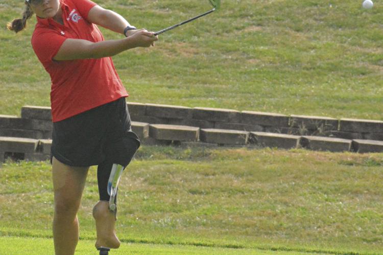 SHAWN RONEY | Staff ISABELLA SMITH watches her chip shot during Richmond’s recent road quadrangular with Excelsior Springs, Norborne and Lawson.