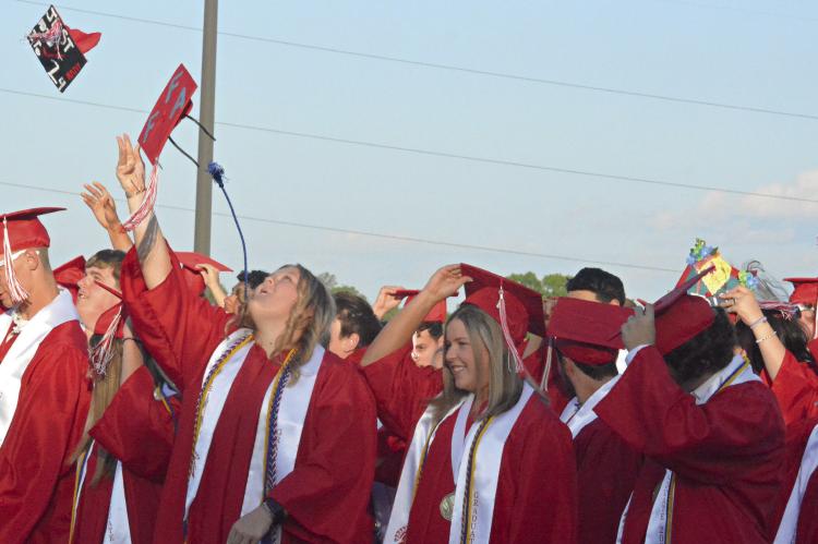 CONTINUING A TRADITION of commencement ceremonies that reportedly began more than 100 years ago at the U.S. Naval Academy, the graduates of Richmond High School’s class of 2024 begin tossing their caps into the air on a sunny, Friday evening at Spartan Stadium. SHAWN RONEY | Staff