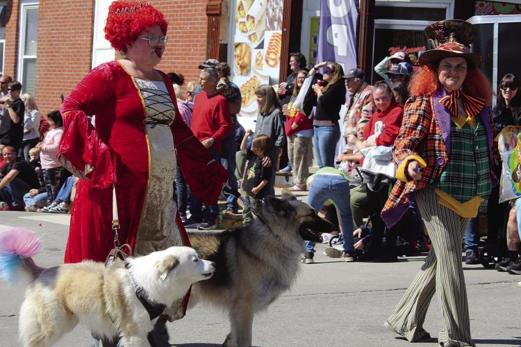 MCKAYLA MABERY (right) walks alongside a Queen of Hearts character while representing VIP Pet Care. SHARON DONAT | Staff