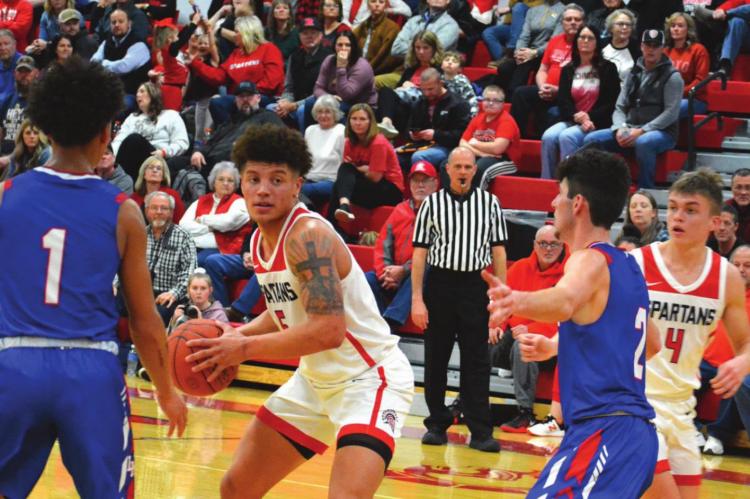 SENIOR KEYSHAUN ELLIOTT surveys the floor from around the free throw line during the Spartans’ 57-38 courtwarming win Feb. 11 over Lexington. SHAWN RONEY | Staff