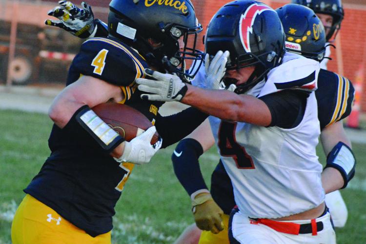 LEVI FIELDER (left) uses a stiff arm move to fight for yards during the Bearcats’ homecoming victory. SHAWN RONEY | Staff