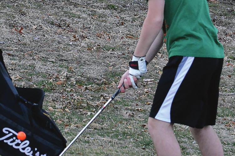 ACCEPTING THE challenge of playing golf, Orrick first-year high schooler Jeffrey Singleton attempts a chip shot March 17 at the Excelsior Springs Golf Course. SHAWN RONEY | Staff