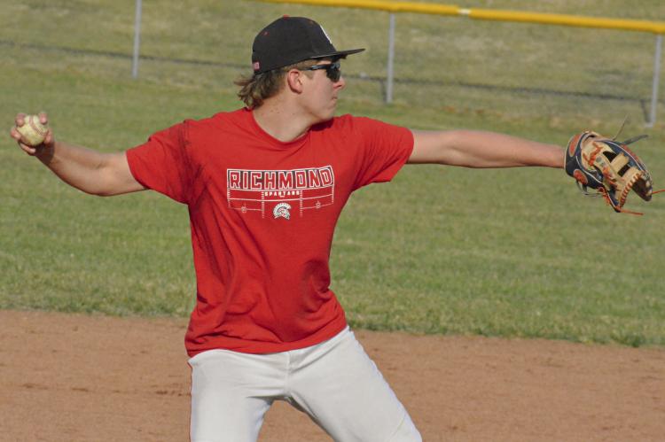 RICHMOND JUNIOR Conner Rodenberg looks to throw to first base during baseball practice.