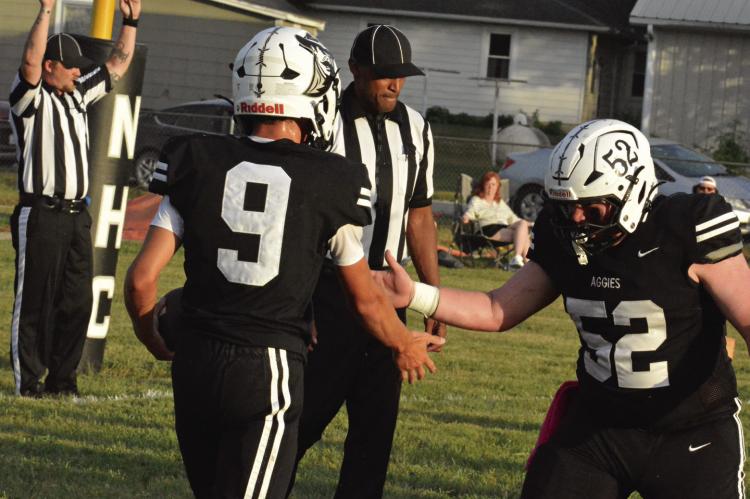 AN OFFICIAL (left) signals a touchdown as Brody Fifer (center) celebrates with Noborne Hardin-Central teammate Jace McNelly following a first-quarter score. SHAWN RONEY | Staff