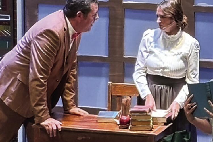 RYAN KUGLER (left) as Professor Harold Hill, speaks with Danielle Greene portraying the librarian, Marian Paroo.