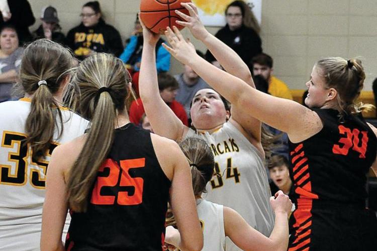 MARA INKS, No. 34, grabs a rebound during Orrick's non-conference meeting Friday night with visiting Hardin-Central. Inks and her fellow Bearcats, who lead 16-13 at halftime, fall 36-32; however, Inks wins the title of courtwarming queen. She is crowned during a ceremony between the girls and boys varsity games.