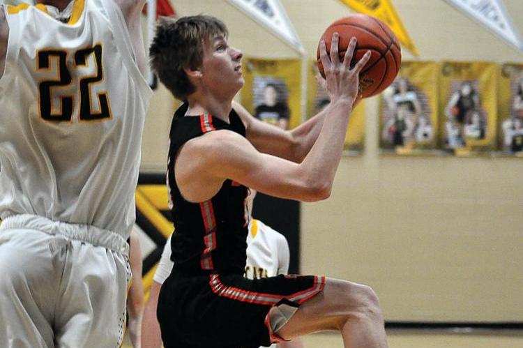 HARDIN-CENTRAL sophomore Mason Freece goes up and under Orrick junior Dylan Comstock to attempt a layup Friday night in non-conference varsity boys basketball action. It is a two-point ballgame at halftime, but Orrick pulls away during the second half for a 55-43 non-conference and courtwarming win. The Bearcats (11-7), who snap a two-game losing streak with their victory, return to I-70 Conference play Tuesday at Crest Ridge. The Bulldogs (3-11) are scheduled Tuesday to host Chilhowee. 