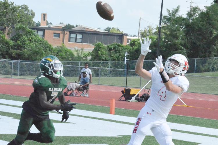 COME TO PAPA: Spartans wide receiver Eli Steele watches a second-quarter TD pass from Donivin Williams float into his hands during Richmond’s 61-26 win over New Madrid County Central Aug. 26 at Ste. Genevieve High School.
