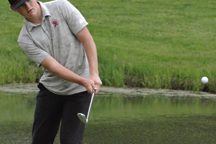 JUNIOR ISAAC KAYLOR watches one of his chip shots during the Richmond Invitational.