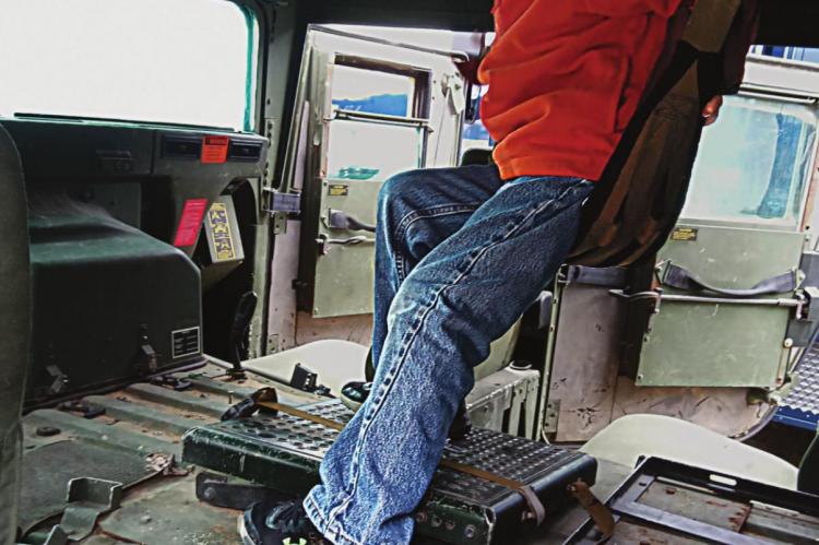 INSIDE the Ray County Sheriff’s Office military surplus MRAP vehicle, Joseph Kinnison, 6, sits in the cloth seat under the turret. SHARON DONAT | Staff affiliate