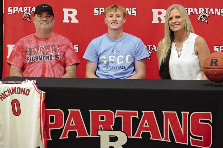 NOLAN QUICK (center) celebrates his decision to study at and play men’s basketball for State Fair Community College in Sedalia with his parents Aaron (left) and Tammy Quick. SHAWN RONEY | Staff