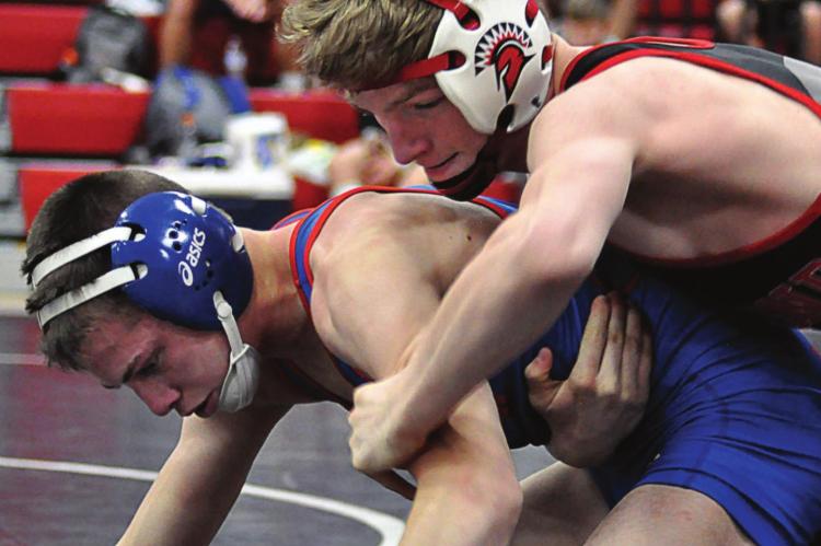 RICHMOND JUNIOR Conner Teat, top, looks to break down Lexington’s Josh Payne in the Missouri River Valley Conference East Division Tournament. SHAWN RONEY | Staff