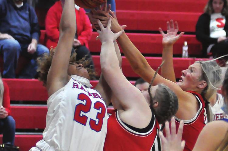 RICHMOND’S Lexi Bokarae, center, and Emmalea Kilpatrick fight with Pembroke Hill’s Jordyn Smith for a first-half rebound while Pembroke Hill junior Ava Rasmus watches Monday night in Richmond Winter Classic action. SHAWN RONEY | Staff