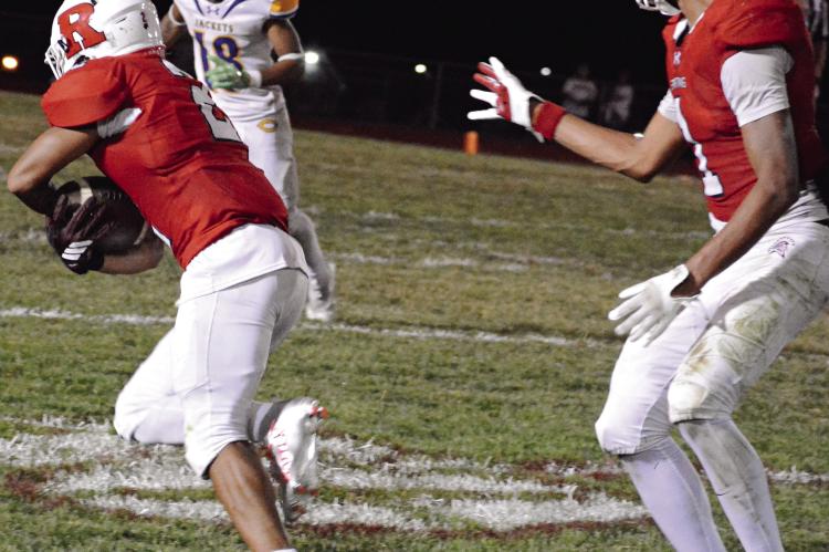 AFTER MAKING A one-handed catch, senior Cyrus Jackson (left) secures the football with both hands and races downfield with teammate Brice Dome watching during Richmond’s homecoming victory over Center. SHAWN RONEY | Staff