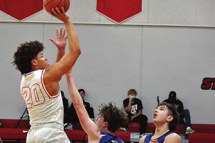 RICHMOND JUNIOR Keyshawn Elliott rises above Holden’s defense to attempt a short, one-handed jump shot. SHAWN RONEY | Staff