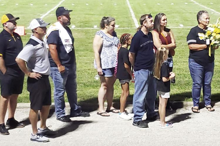 MEMBERS OF Ritchie Vick’s family participate in a halftime tribute to the late supporter of Orrick sports Sept. 2 at Simmons Field. NICOLE SCOTT | Staff