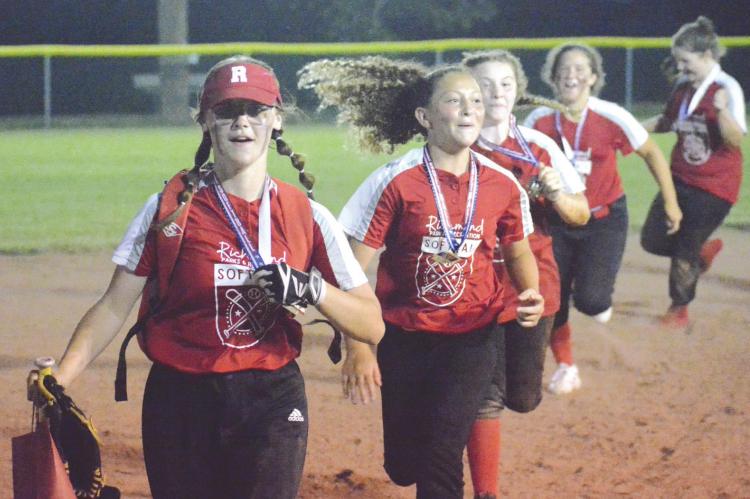 MEMBERS OF THE Richmond 1-Ellis Farms ballclub display their medals and run a victory lap around the bases after winning the Tri-County 13U Softball Tournament Tuesday night at Southview Park. SHAWN RONEY | Staff