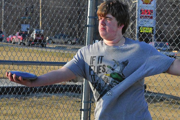 AT THE press’ request, Richmond sophomore Jake Cringan attempts a discus throw late in the afternoon March 3 on the high school campus. SHAWN RONEY | Staff